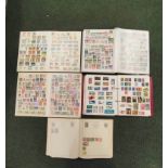 Five well filled albums of World & Commonwealth postage stamps to include issues from Iraq, Papua