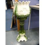 Green glazed ceramic jardinière on stand.