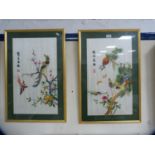 Pair of reproduction Chinese embroideries on silk depicting peacocks in foliage.  (2)