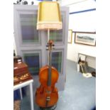 Novelty floor lamp modelled as a cello, with shade.
