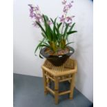 Wicker occasional table and a faux orchid arrangement.  (2)