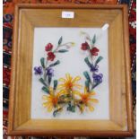 Glass floral collage in a glazed display case.