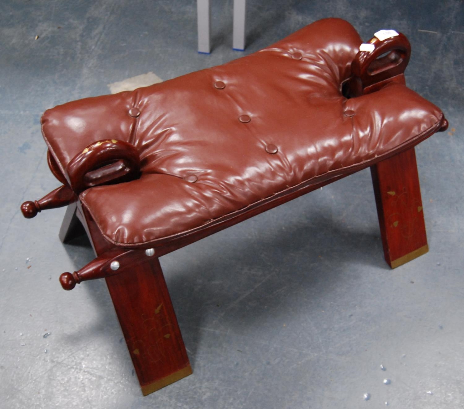 Syrian-style hardwood camel stool with padded top.