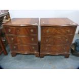 Pair of reproduction serpentine fronted three-drawer bedside chests.  (2)