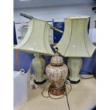 Pair of Chinese-style ceramic table lamps decorated with prunus blossom, with shades, and another
