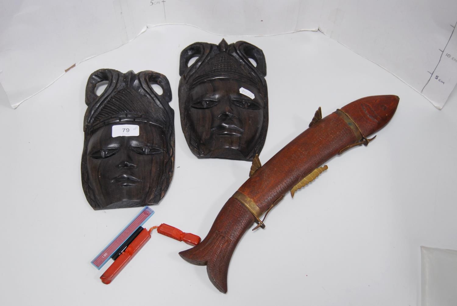 Two reproduction East African wall masks modelled as tribal females, also a carving set modelled
