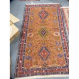 Orange ground rug with stylised animals and an Afghan-style rug.  (2)