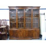 Reproduction mahogany breakfront bookcase enclosed by astragal glazed doors.