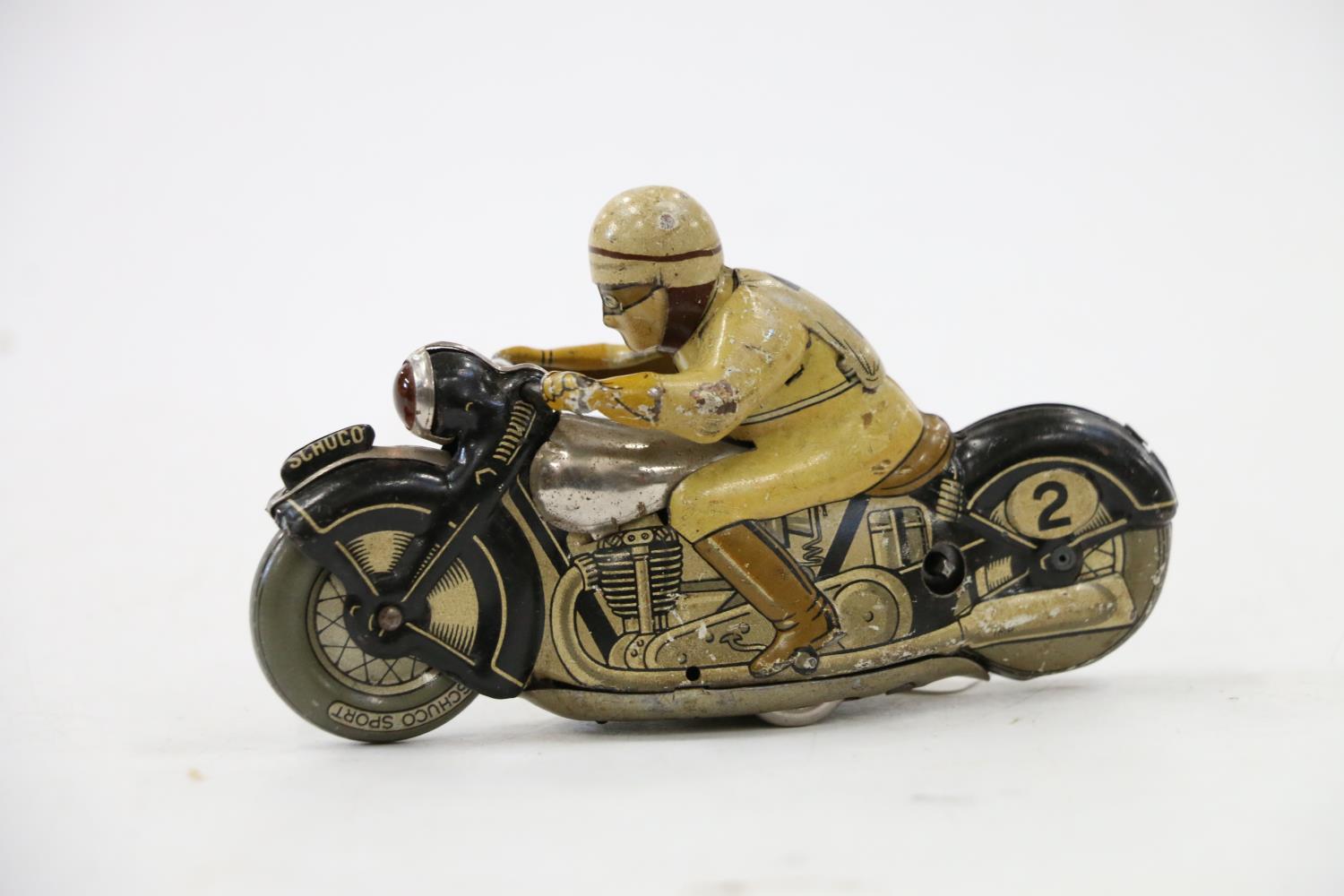 Schuco of Germany, a tinplate clockwork motorcycle and rider #2 N1012, 13cm long.