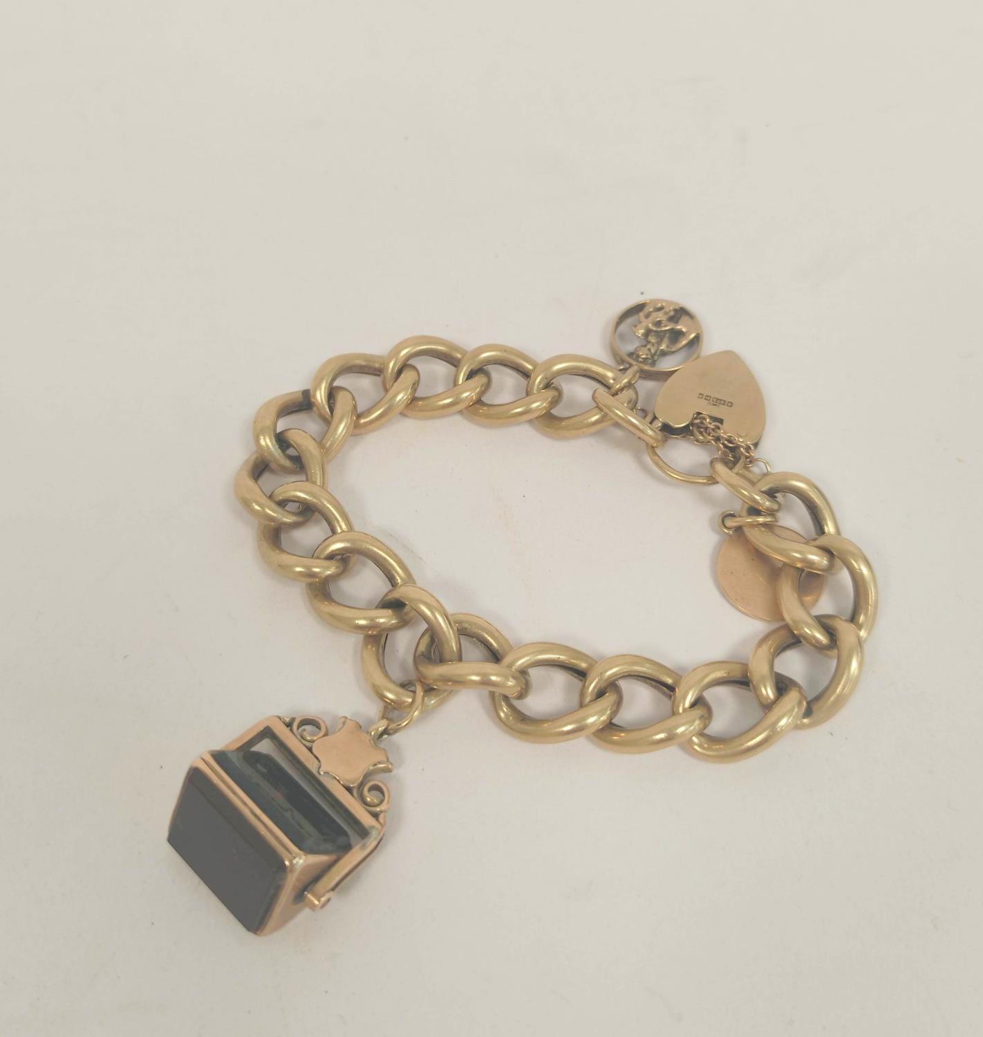 Gold hollow curb bracelet with rotating seal and two charms, 42g gross.