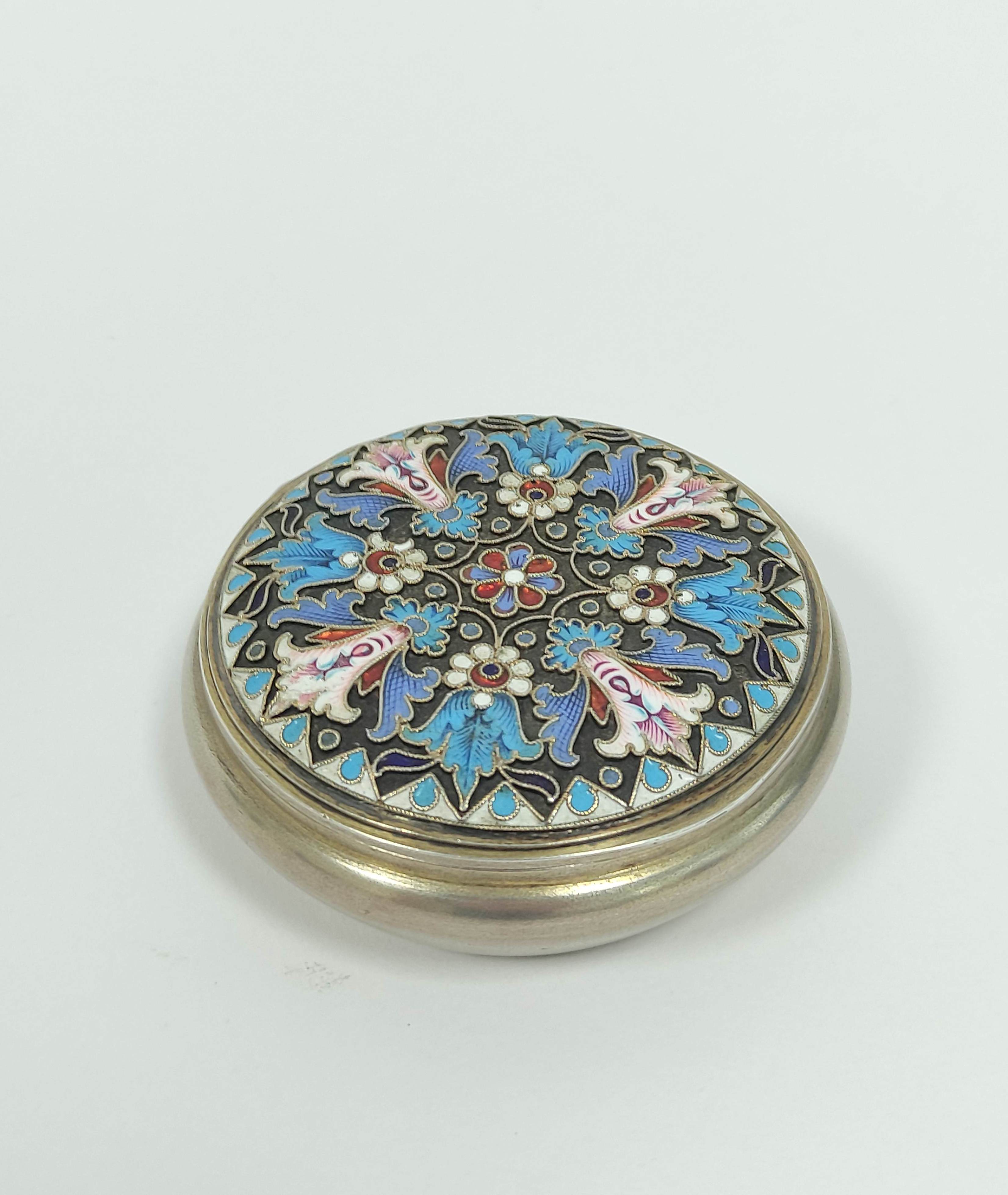 Faberge silver gilt and enamel circular box with angular sides and cover in blue, white pink and