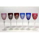 Near matching set of six Bohemian wine glasses with cut flashed bowls on tapered faceted stems in