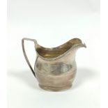 Silver cream jug, oval with pin struck cartouches and wavy bands, reeded handle, makers mark rubbed,