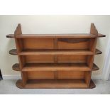 Late 19th century oak open bookcase in the Arts and Crafts manner, the four shelves linked by fret