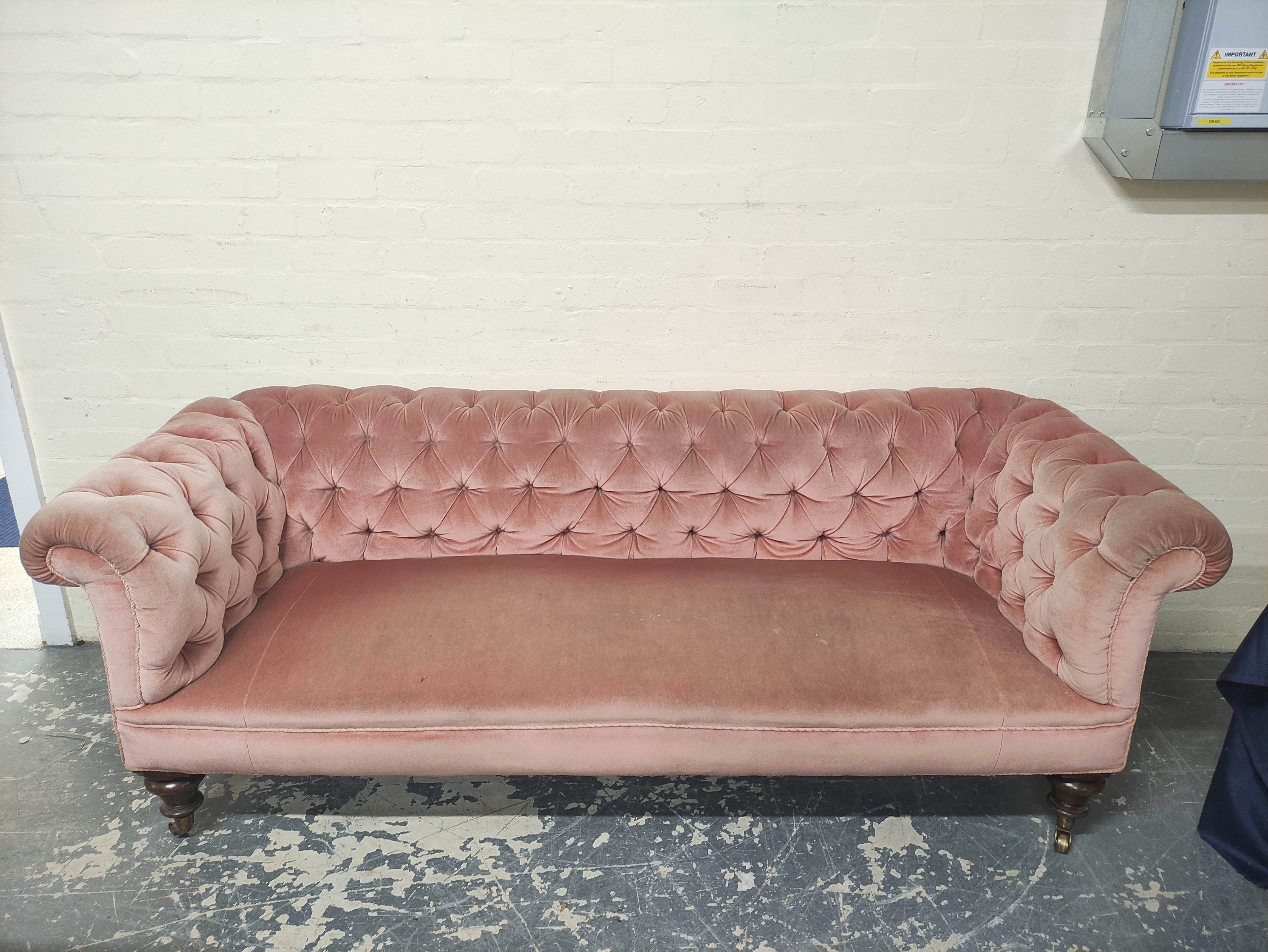 Victorian Chesterfield style sofa upholstered in later pink button back velour, on mahogany turned