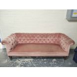 Victorian Chesterfield style sofa upholstered in later pink button back velour, on mahogany turned