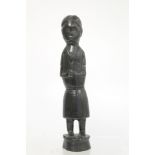 Ethnic, probably African, carved ebony standing figure of a man (European missionary / priest?) on