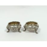 Pair of cast silver salts and good gauge with embossed swags, upon lion mask and furry paw feet,