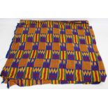 African Asanti Kente cloth in woven silk and cotton fabrics in predominantly blue, yellow, green and