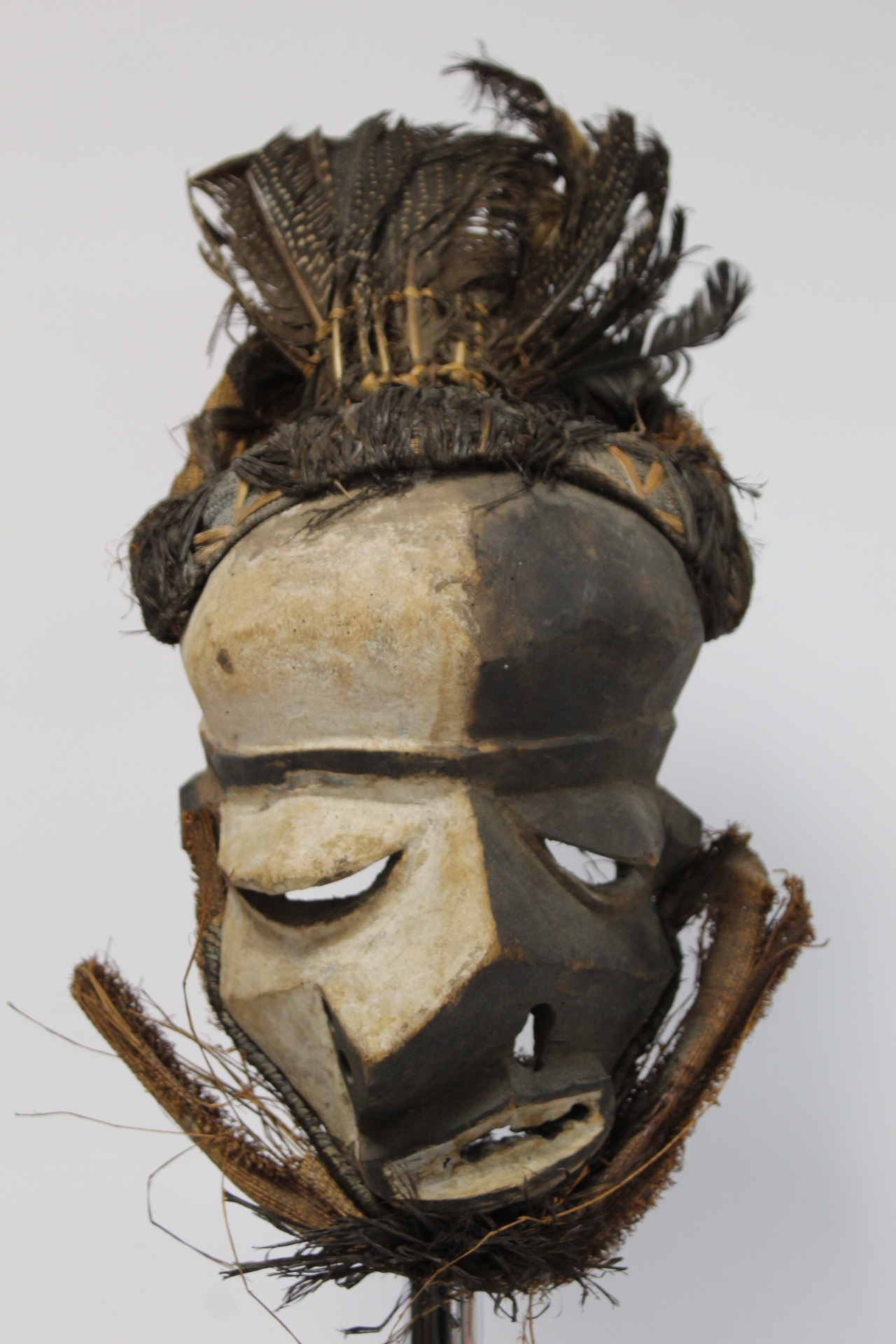 African tribal DRC Pende Mbangu sickness mask, the abstract carved wooden face with black and