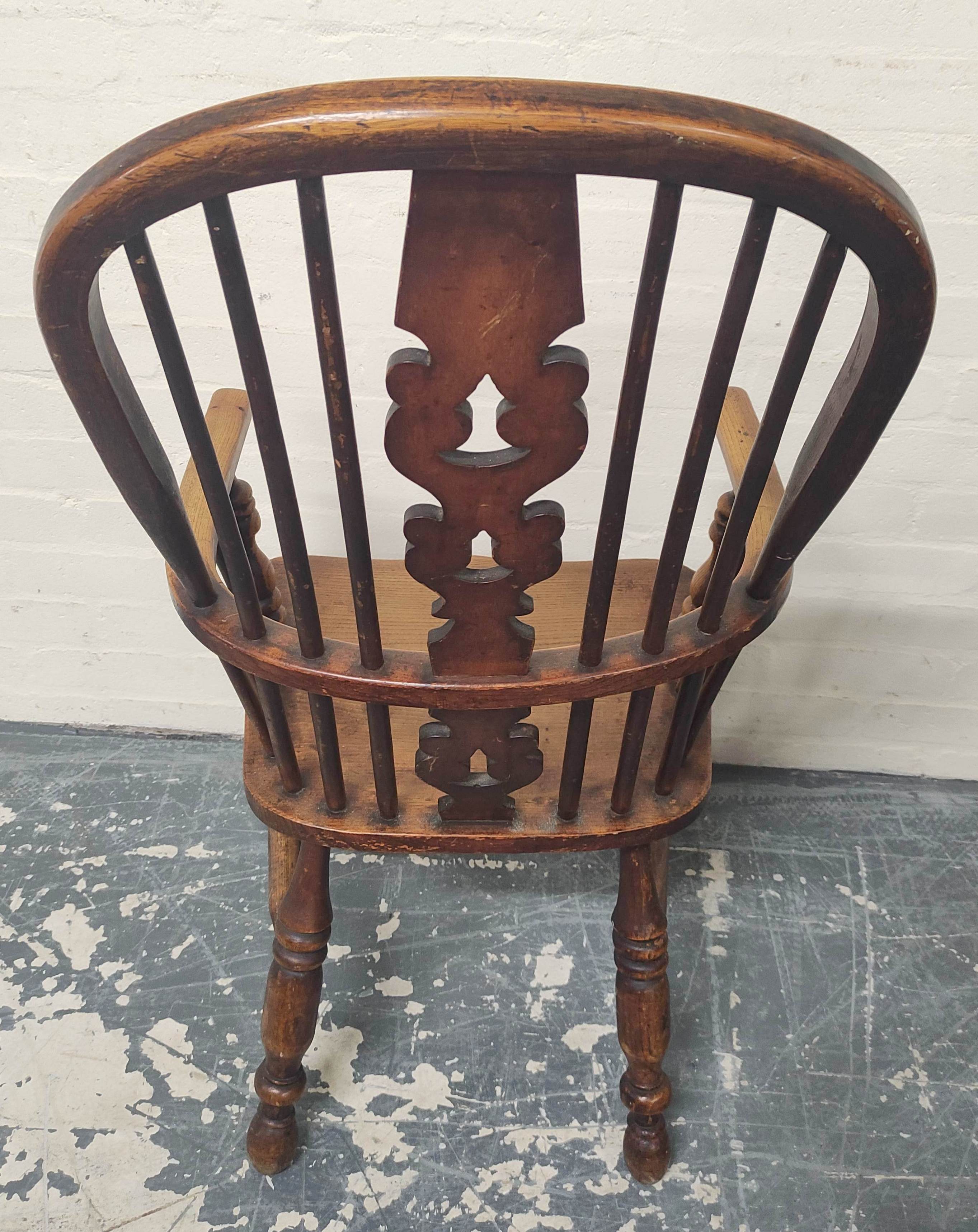 Ash and elm Windsor armchair, the hoop frame with spindle back and pierced splat, raised on turned - Image 4 of 4