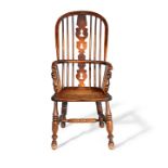 Ash and elm Windsor armchair, the hoop frame with spindle back and pierced splat, raised on turned