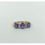 Diamond and tanzanite three stone ring,. in gold, probably 18ct, size 'K½'.