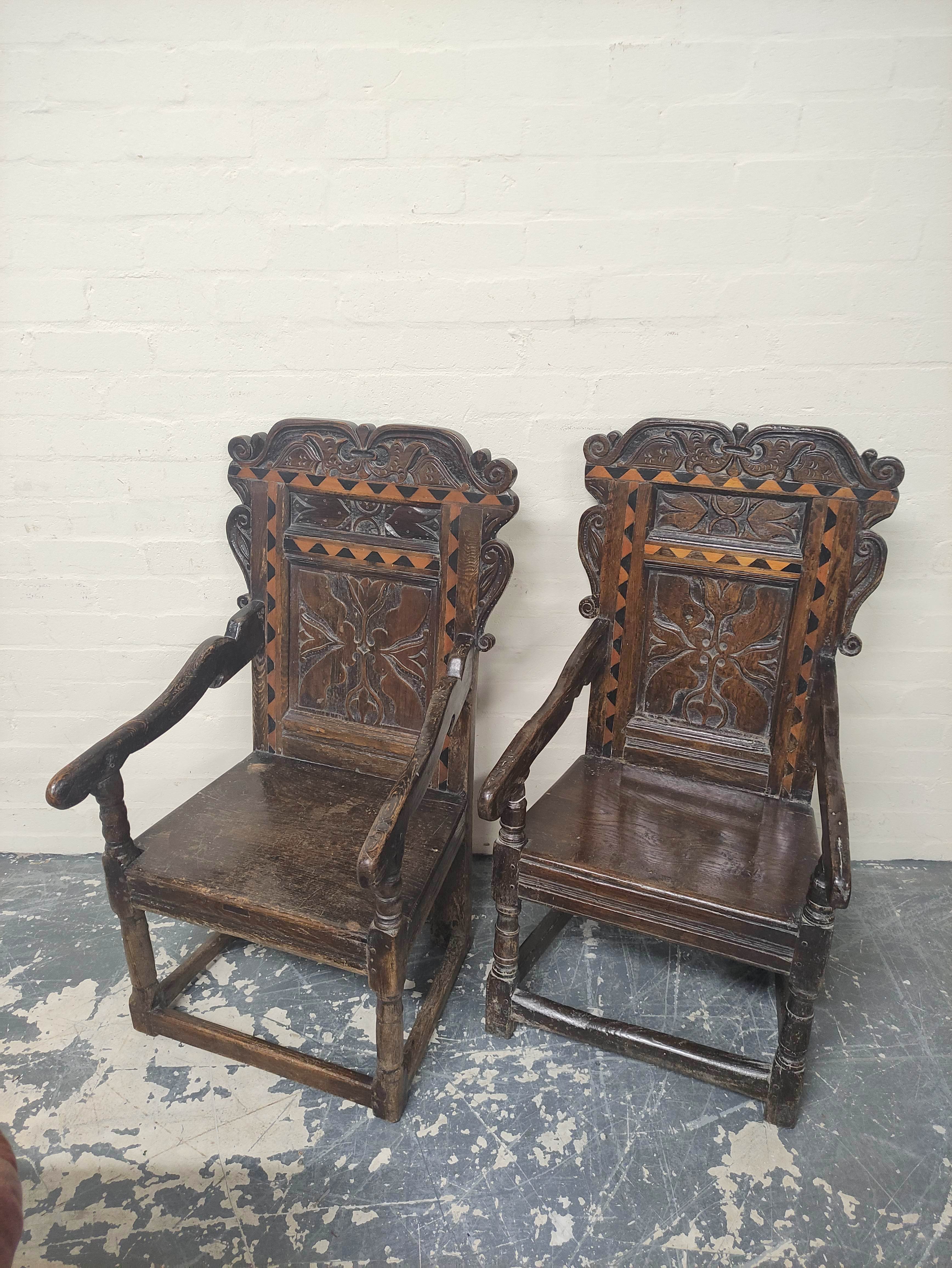 Near pair 17th century oak panel back armchairs, West Yorkshire, the shaped top rails with carved