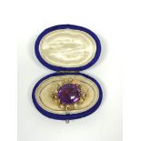 Victorian coloured gold oval brooch with oval amethyst, 20mm, in a wreath of leaves and flower