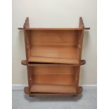 Late 19th century oak wall hanging open book shelves in  the Arts and Crafts manner, adjustable