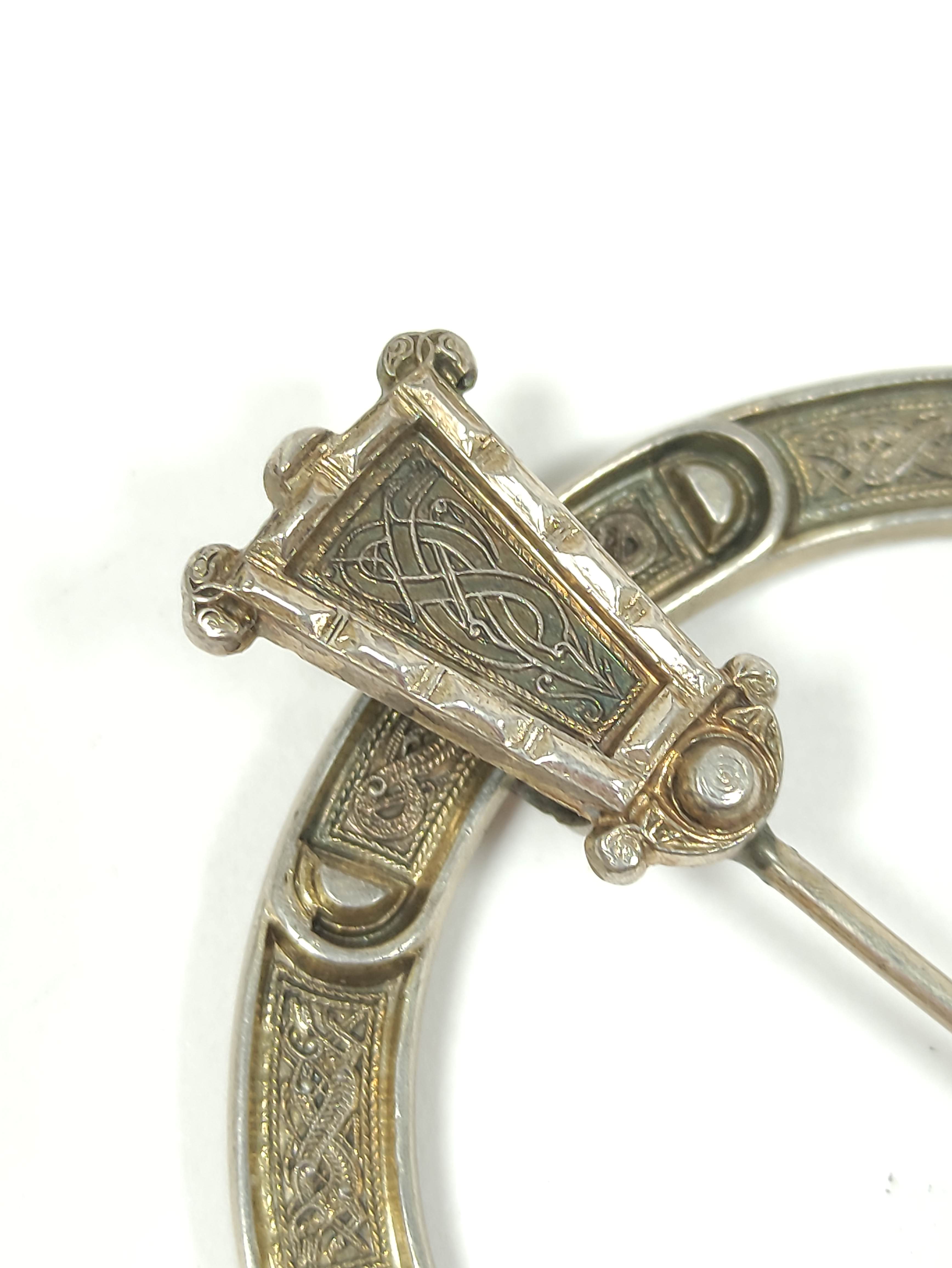 Silver gilt penannular pin, unmarked with embossed Celtic motifs and plain back, 70mm. - Image 2 of 4