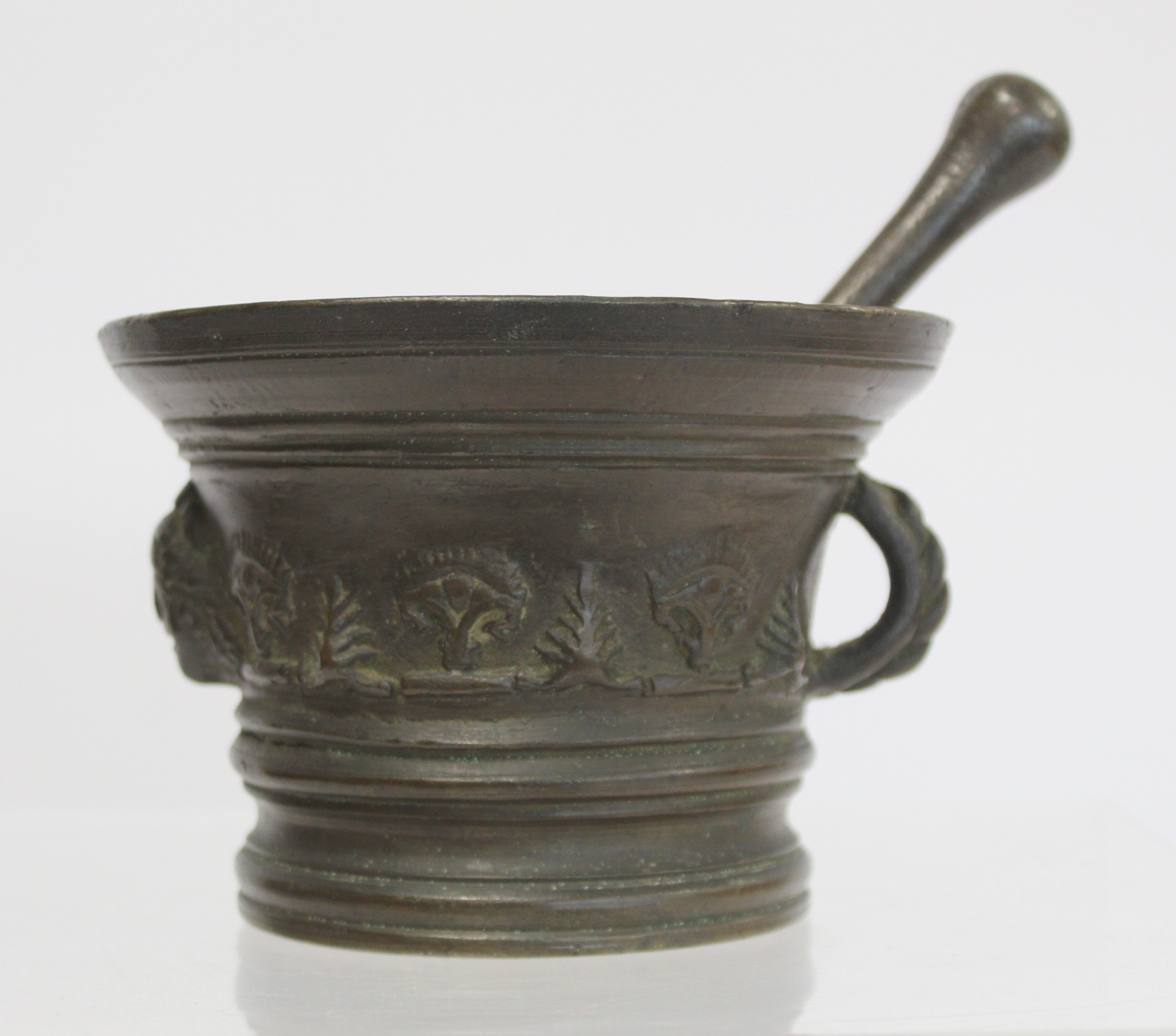 17th century bronze mortar and pestle, the mortar of flared circular form with single rope twist