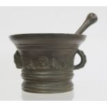 17th century bronze mortar and pestle, the mortar of flared circular form with single rope twist