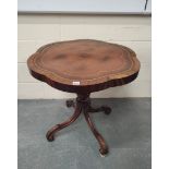 Antique and later mahogany occasional table, the shaped top with tooled inset, on turned column