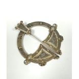 Silver gilt penannular pin, unmarked with embossed Celtic motifs and plain back, 70mm.