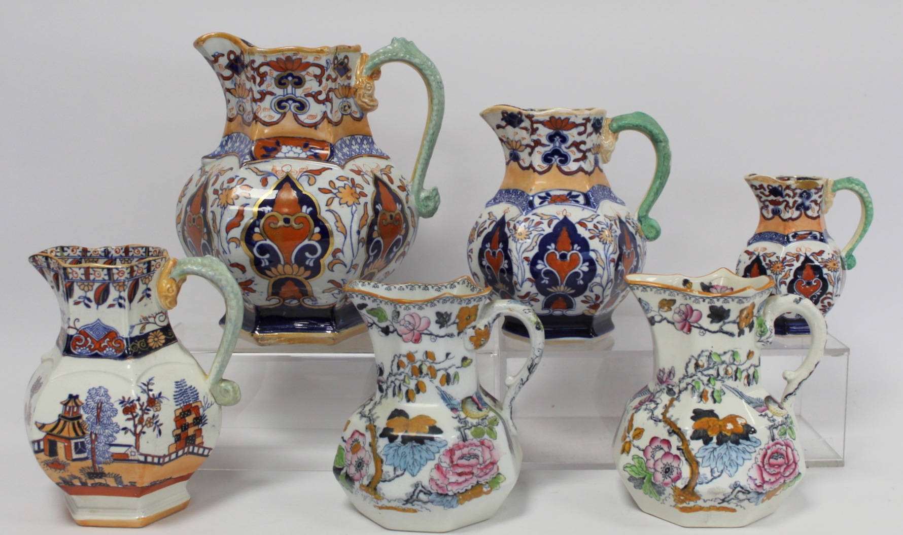 Masons Ironstone graduated set of three hexagonal jugs with dolphin handles decorated in the Imari