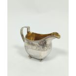 Silver cream jug of curved rectangular shape with engraved band, marked by mistake on both the