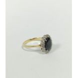 Diamond and sapphire oval cluster ring with small brilliants in gold, '18ct', size 'P'.