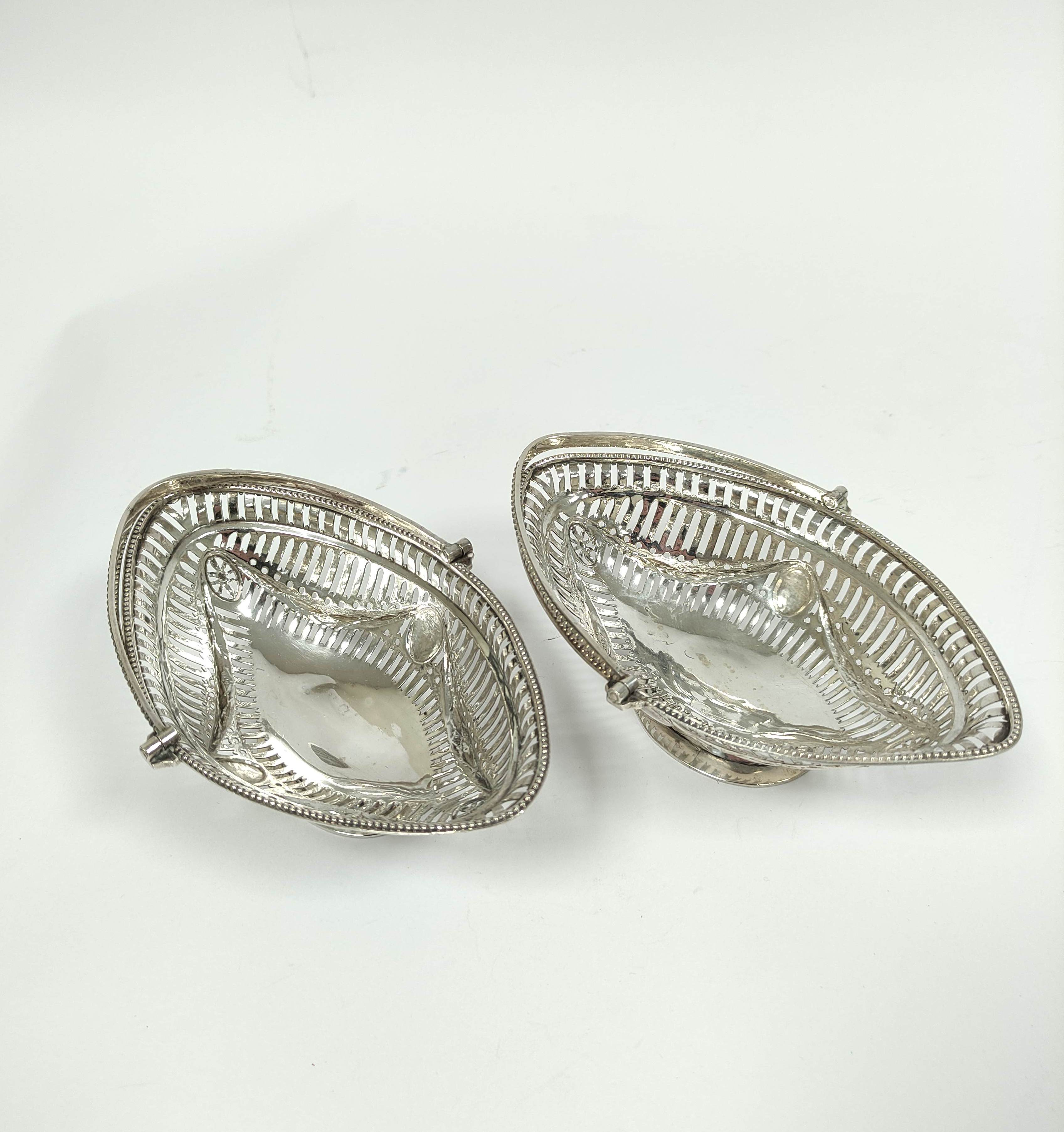 Attractive pair of oval sweetmeat baskets of Neo Classical style, with pierced and embossed swags