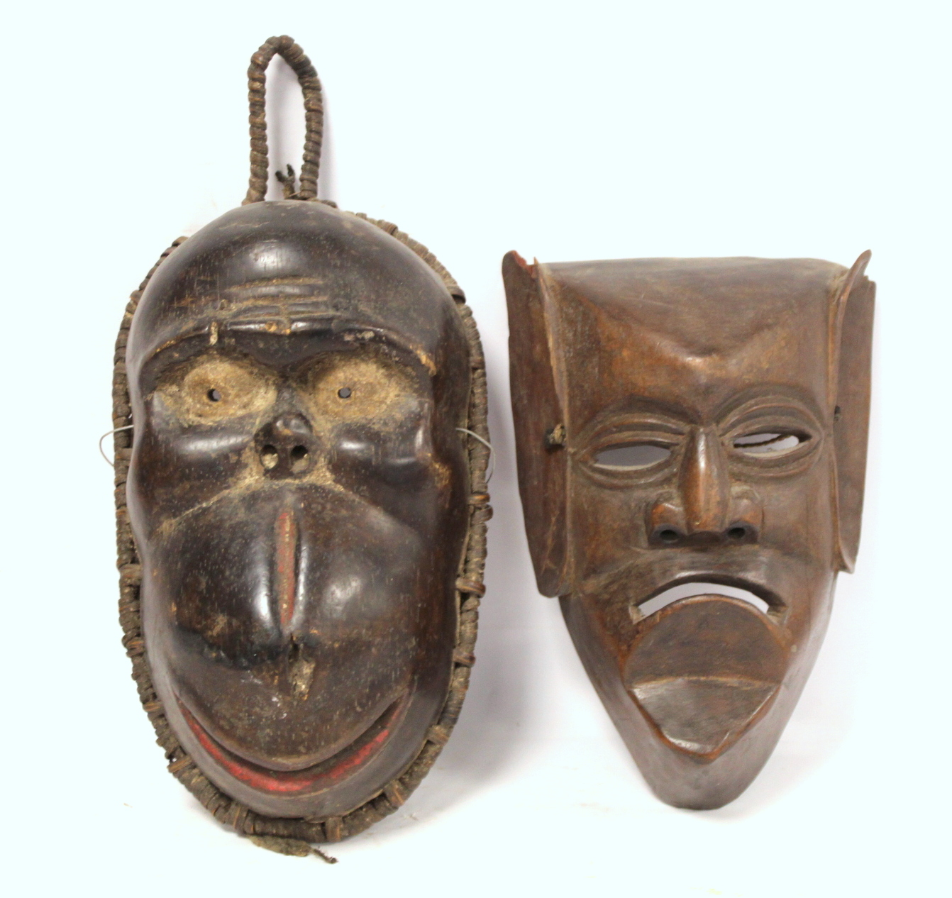 African carved hardwood monkey mask decorated with white and red pigments, with cane binding and