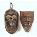 African carved hardwood monkey mask decorated with white and red pigments, with cane binding and