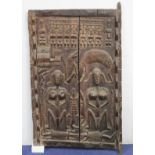 West African carved wooden door, probably Ivory Coast, profusely decorated with figures and animals,
