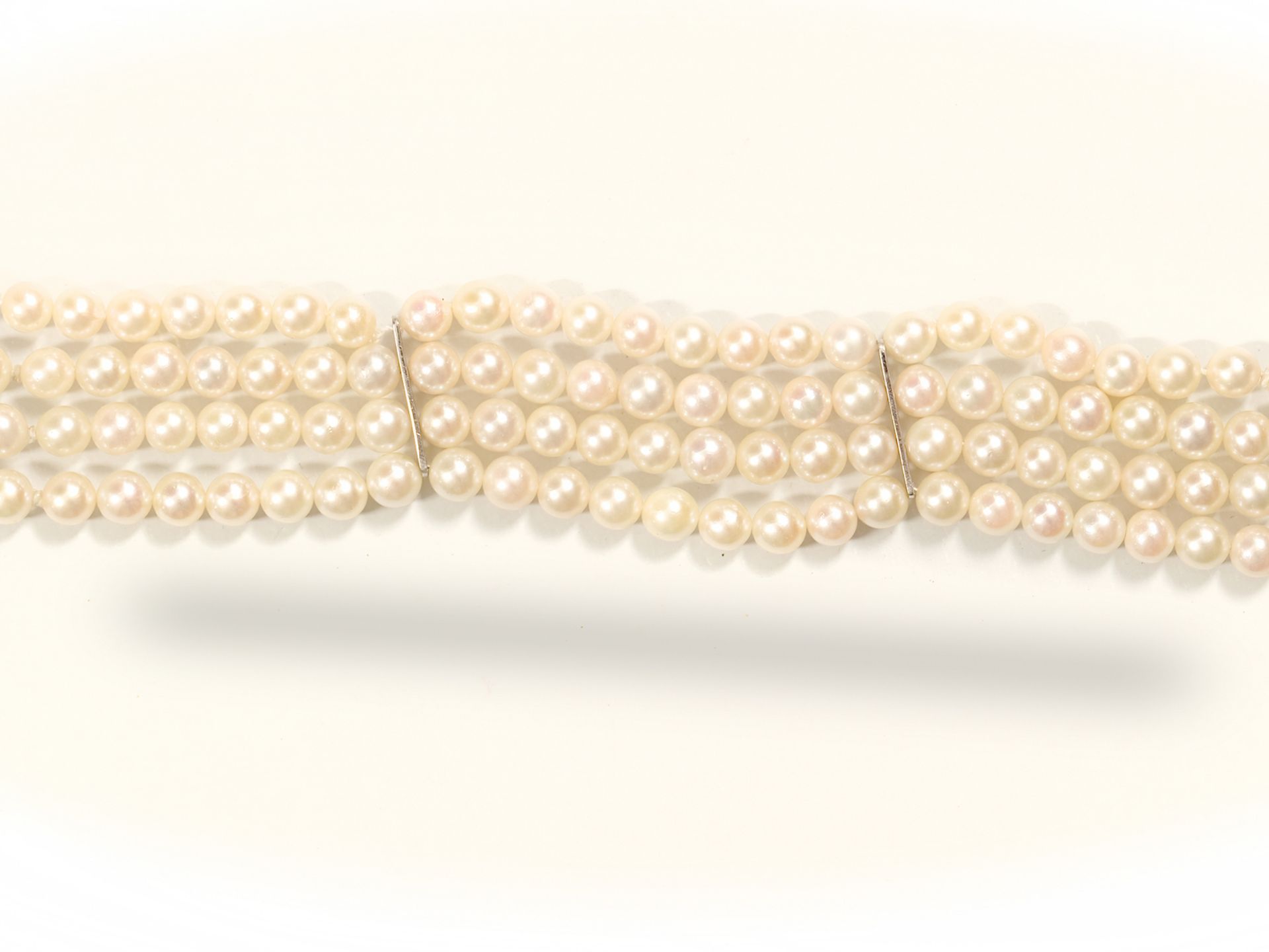 Bracelet of four rows of pearls, 
With white gold mounting and diamonds, 
Ca. 1970