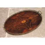 A George III inlaid mahogany oval tray, with a pierced brass gallery and brass side handles,