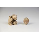 * A Chinese carved stone model of a Dog of Fo, designed with two playful cubs, 3.5cm high, with a