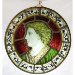 An oval stained and painted glass portrait panel, 19th century, depicting a young gentleman in