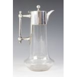 A cut glass silver plated decanter in the manner of Christopher Dresser, of baluster form with cut