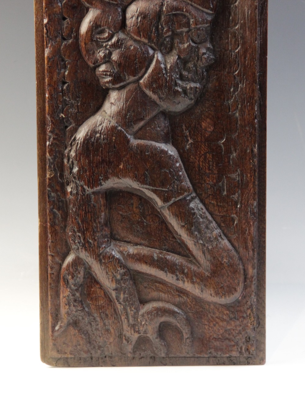 A 16th century carved oak panel, carved with a grotesque beast against a naïve scalloped and foliate - Image 3 of 4