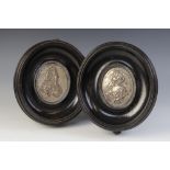 A pair of silver coloured William & Mary commemorative plaques, 18th Century, depicting repoussé