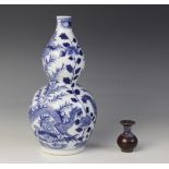 * A Chinese porcelain blue and white gourd vase, 19th century, of double gourd form and externally